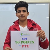 Student Tarush holding placard of got 90 points in PTE
