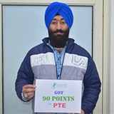 Student Angrej Singh holding placard of got 90 points in PTE