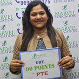 Student Bhawna holding placard of got 90 points in PTE