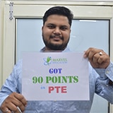 Student Hasrat holding placard of got 90 points in PTE