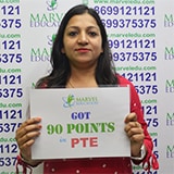 Student Rachna holding placard of got 90 points in PTE